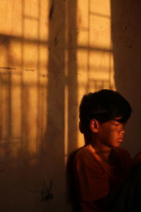 Portrait of boy looking through window