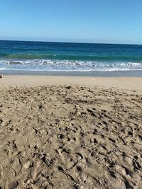 Scenic view of beach against clear sky