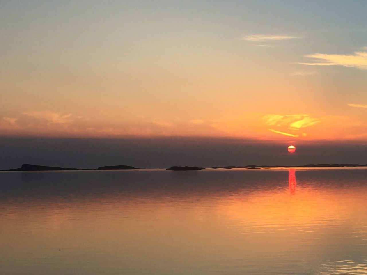 sunset, reflection, beauty in nature, water, scenics, tranquility, nature, tranquil scene, sky, idyllic, outdoors, waterfront, no people, sun, sea, day