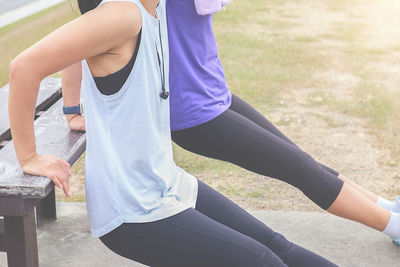 Low section of friends exercising at public park