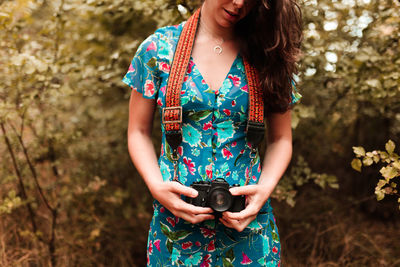 Midsection of woman holding smart phone