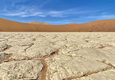 Scenic view of desert against blue sky