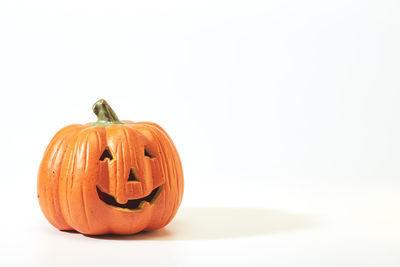 Close-up of pumpkin on plate against white background