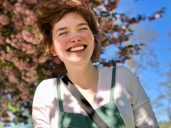 Smiling woman against trees