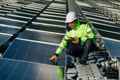 The portrait of a male engineer checks photovoltaic solar panels