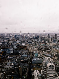 High angle view of buildings against sky with raindrops