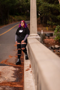 Rear view of man walking on footpath