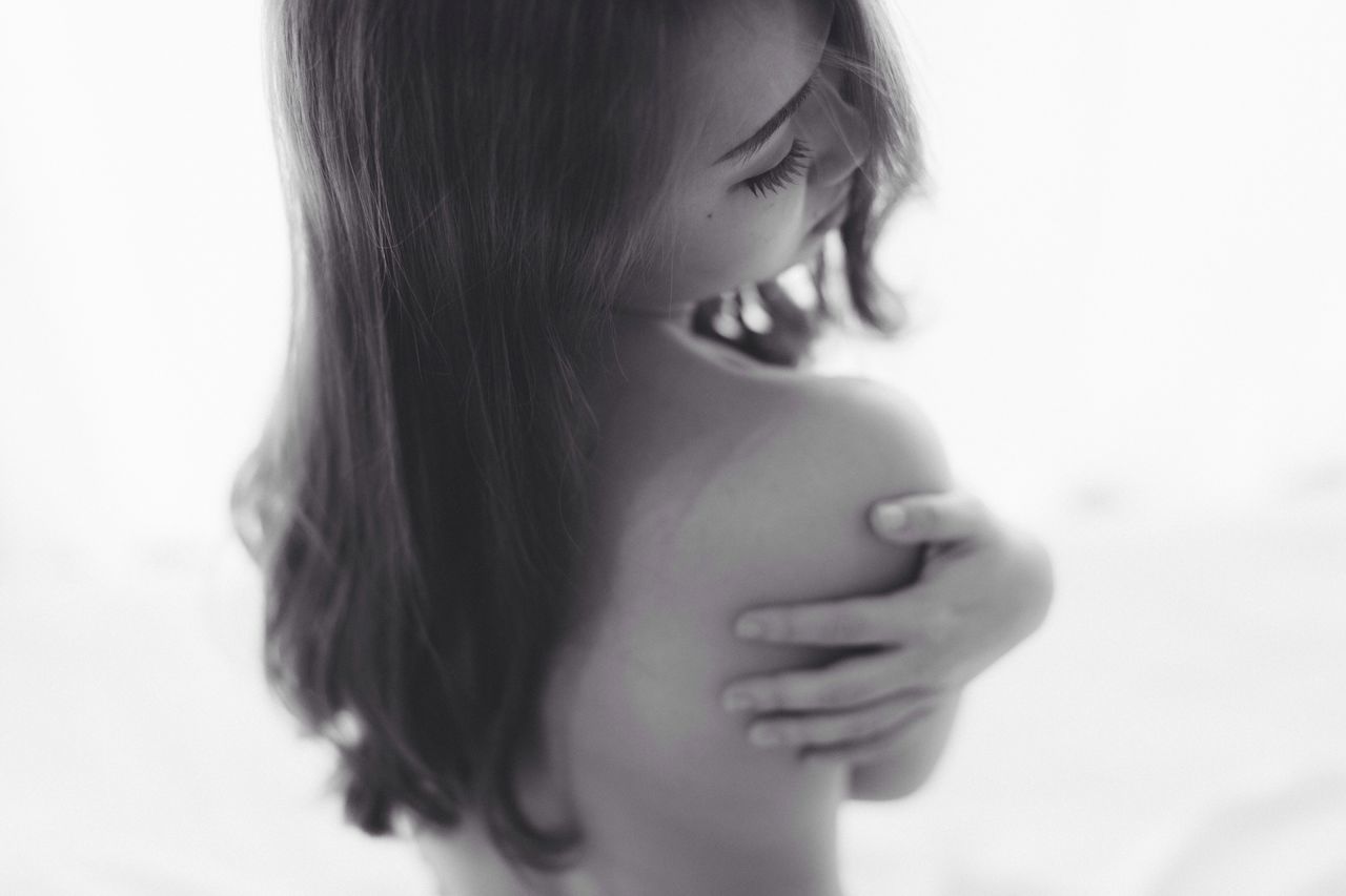 studio shot, one person, close-up, lifestyles, headshot, real people, young adult, young women, looking down, white background, childhood, women, portrait, indoors, one young woman only, human hand, day, people, adult