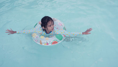 Portraits of asian girl wearing a swimsuit. swimming in the pool