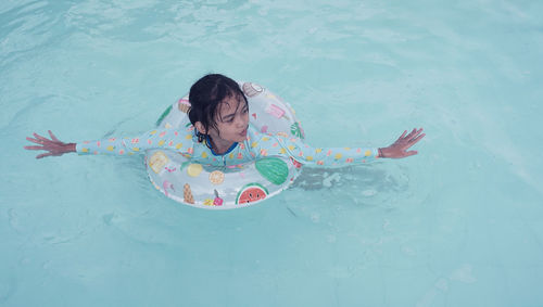 High angle view of woman swimming in sea