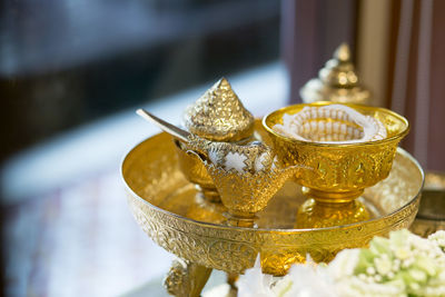 Close-up of gold colored table