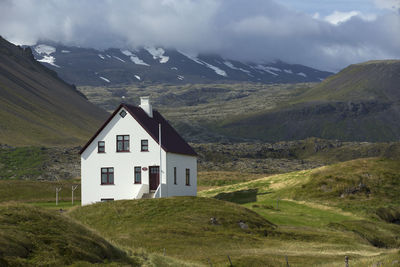 Scenic view of mountains and houses against sky