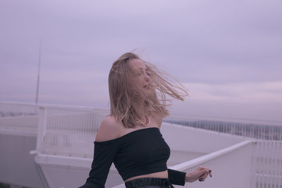 Woman standing in water against sky