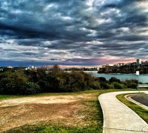 Cityscape against cloudy sky