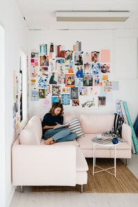 Woman sitting on sofa in living room