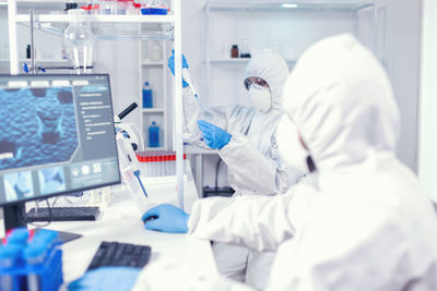 Midsection of scientist working in laboratory