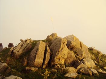 Rocks on mountain against sky