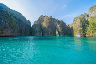 Scenic view of sea and mountains against sky