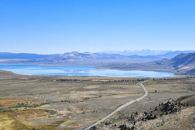 Scenic view of landscape and mountains against clear blue sky