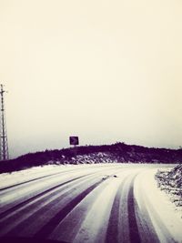 Road passing through snow covered landscape