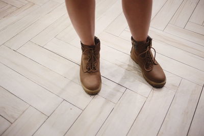 Low section of woman standing on tiled floor