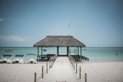 Lifeguard hut on beach against sky