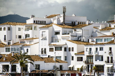 Residential buildings in city against sky