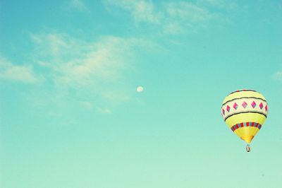 Low angle view of hot air balloons against blue sky