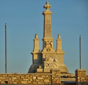 Low angle view of statue against sky