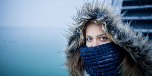 Close-up portrait of young woman during winter