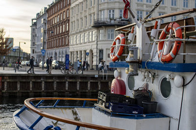 Boats moored in canal in city