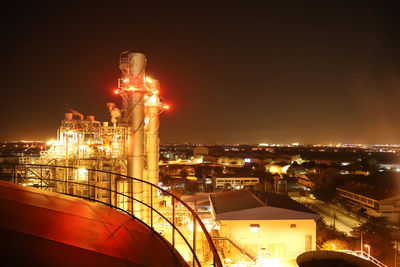 High angle view of illuminated buildings against sky at night