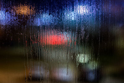 Full frame shot of wet glass window during rainy season