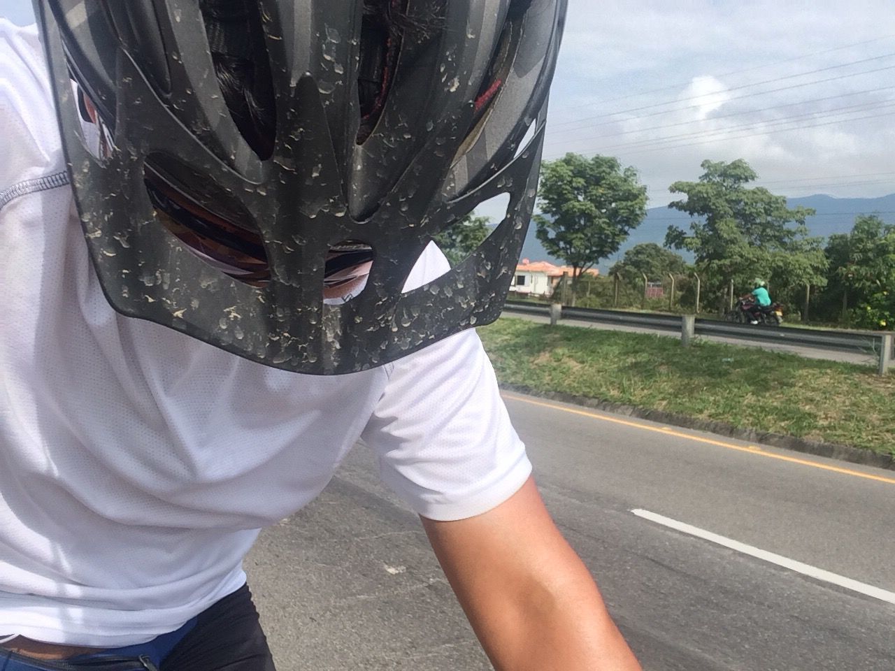 MIDSECTION OF MAN STANDING ON ROAD AGAINST SKY