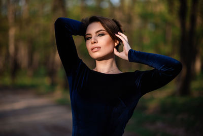 Portrait of beautiful young woman standing outdoors