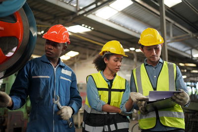 Industrial engineers work at the heavy industry manufacturing factory.