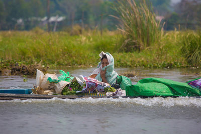 Side view of man lying on garbage