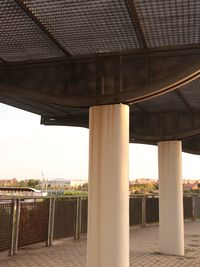 Low angle view of bridge in city against sky