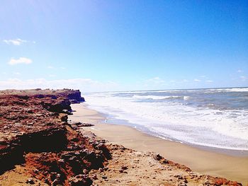 Scenic view of sea against blue sky