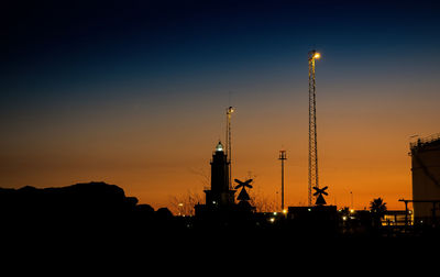 Silhouette of communications tower at sunset