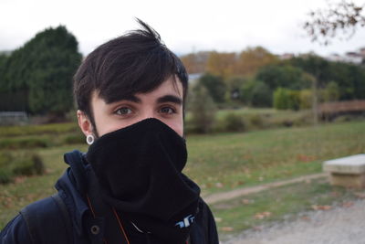 Close-up portrait of man against sky