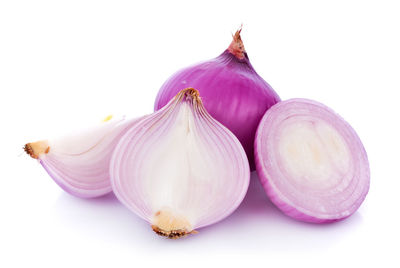 Close-up of onions against white background