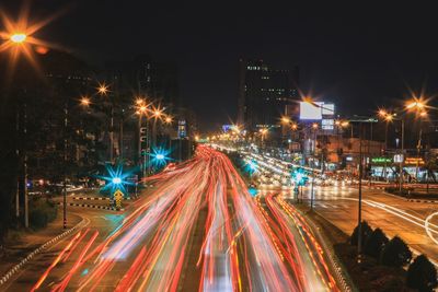 High angle view of light trails on road at night