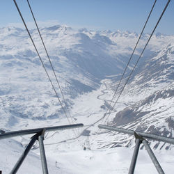 Overhead cables on snowcapped mountain
