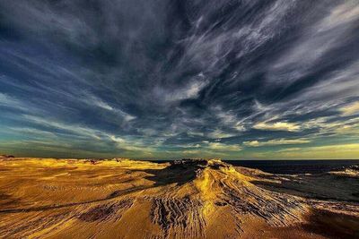 Scenic view of sea against cloudy sky