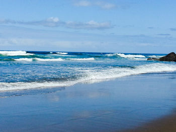 Scenic view of sea against blue sky