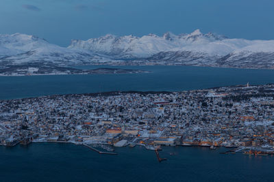 High angle view of river in town against sky during winter