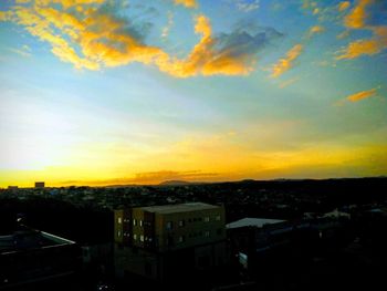 High angle view of buildings against sky during sunset