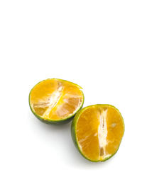 Close-up of lemon slice against white background