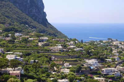 High angle view of townscape by sea against sky